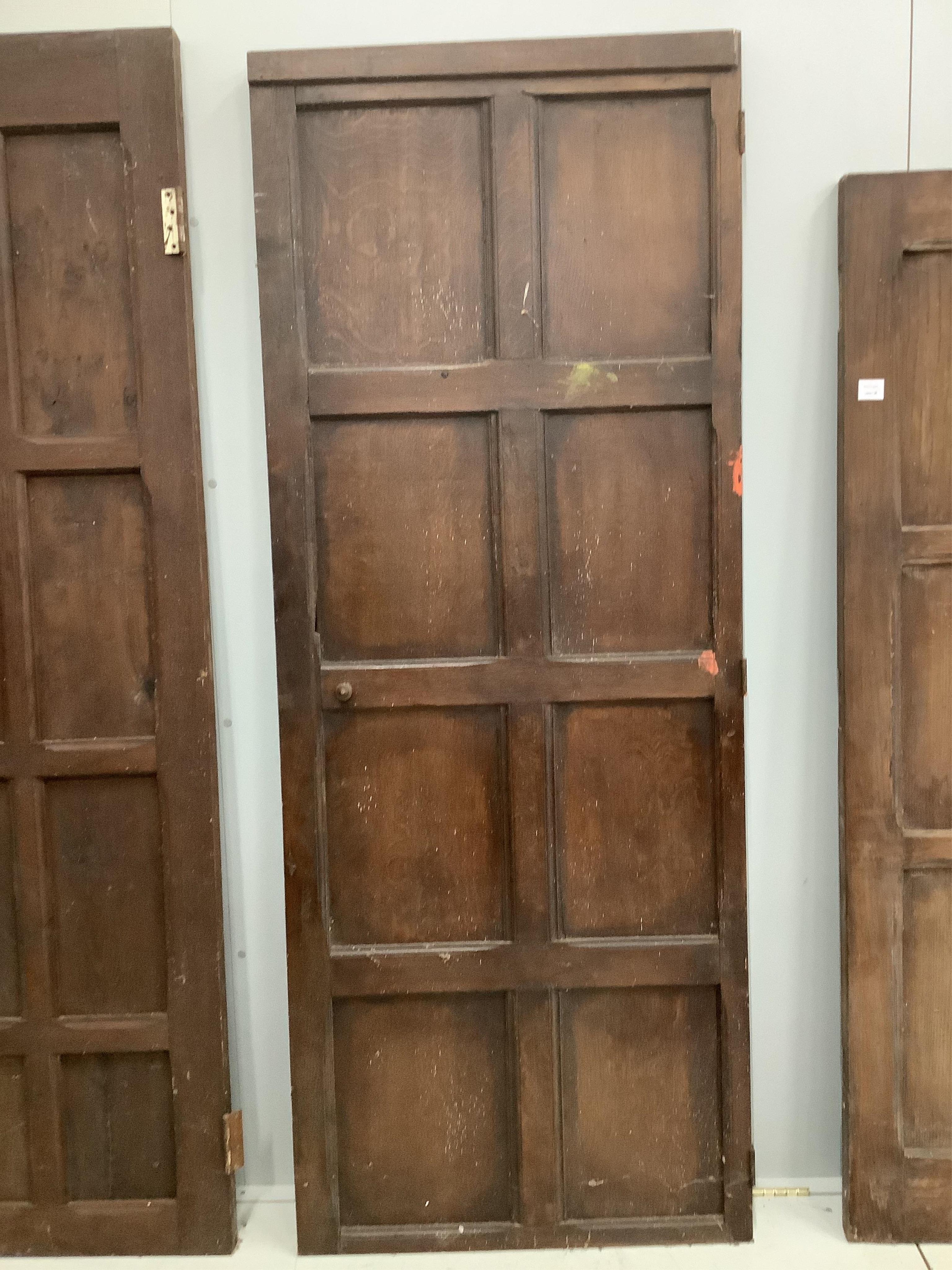 Three various panelled oak doors, largest width 107cm, height 181cm. Condition - poor to fair